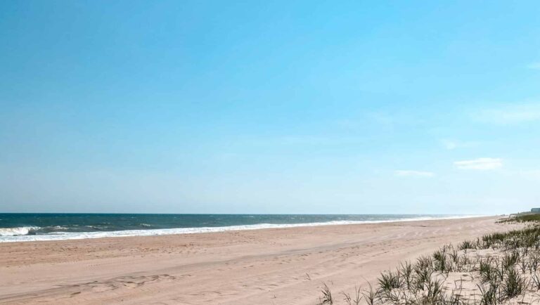 A Hamptons beach with white sand and dunes at the start of summer 2026