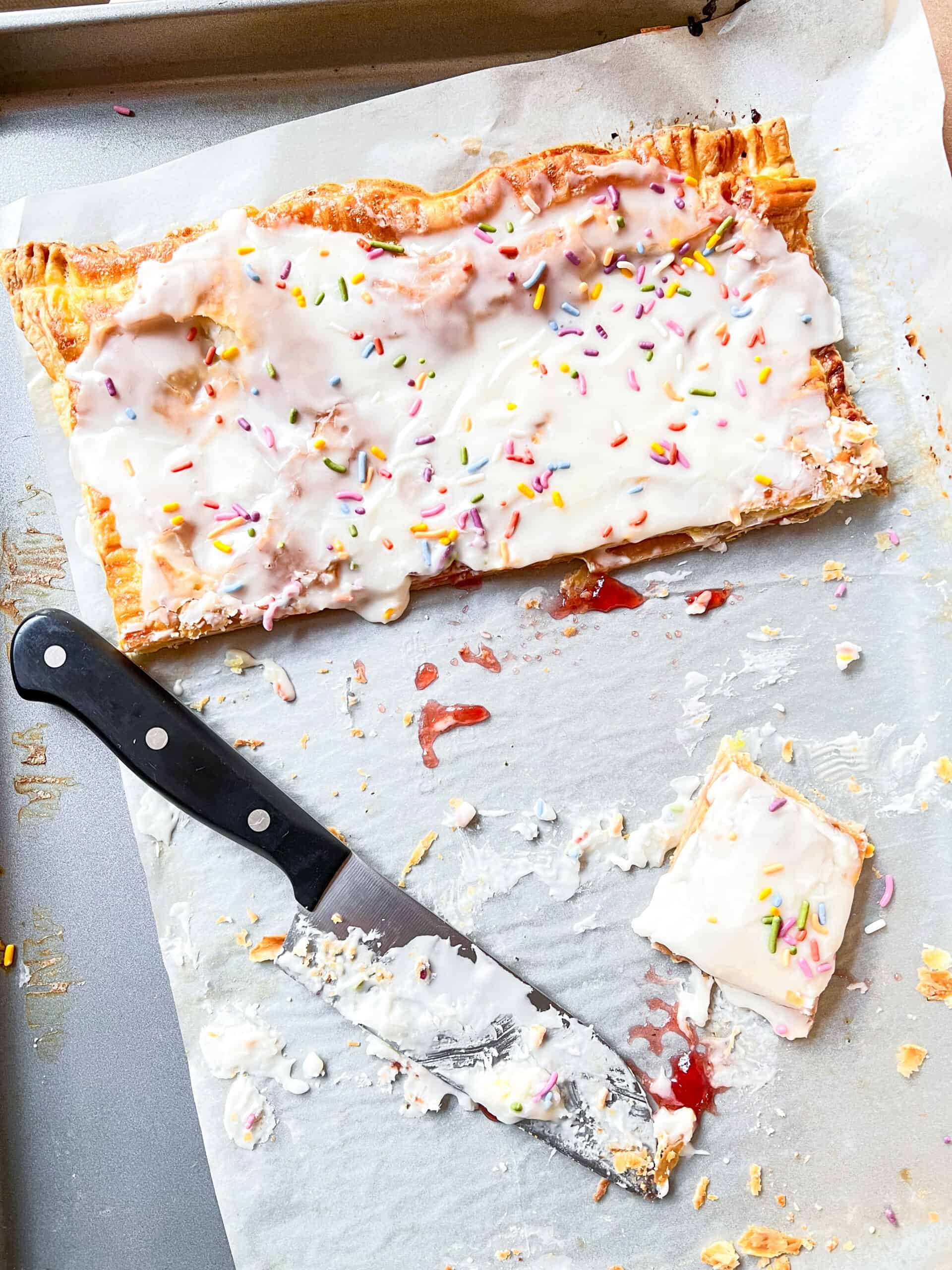 Giant Strawberry Pop Tart with icing and sprinkles sliced
